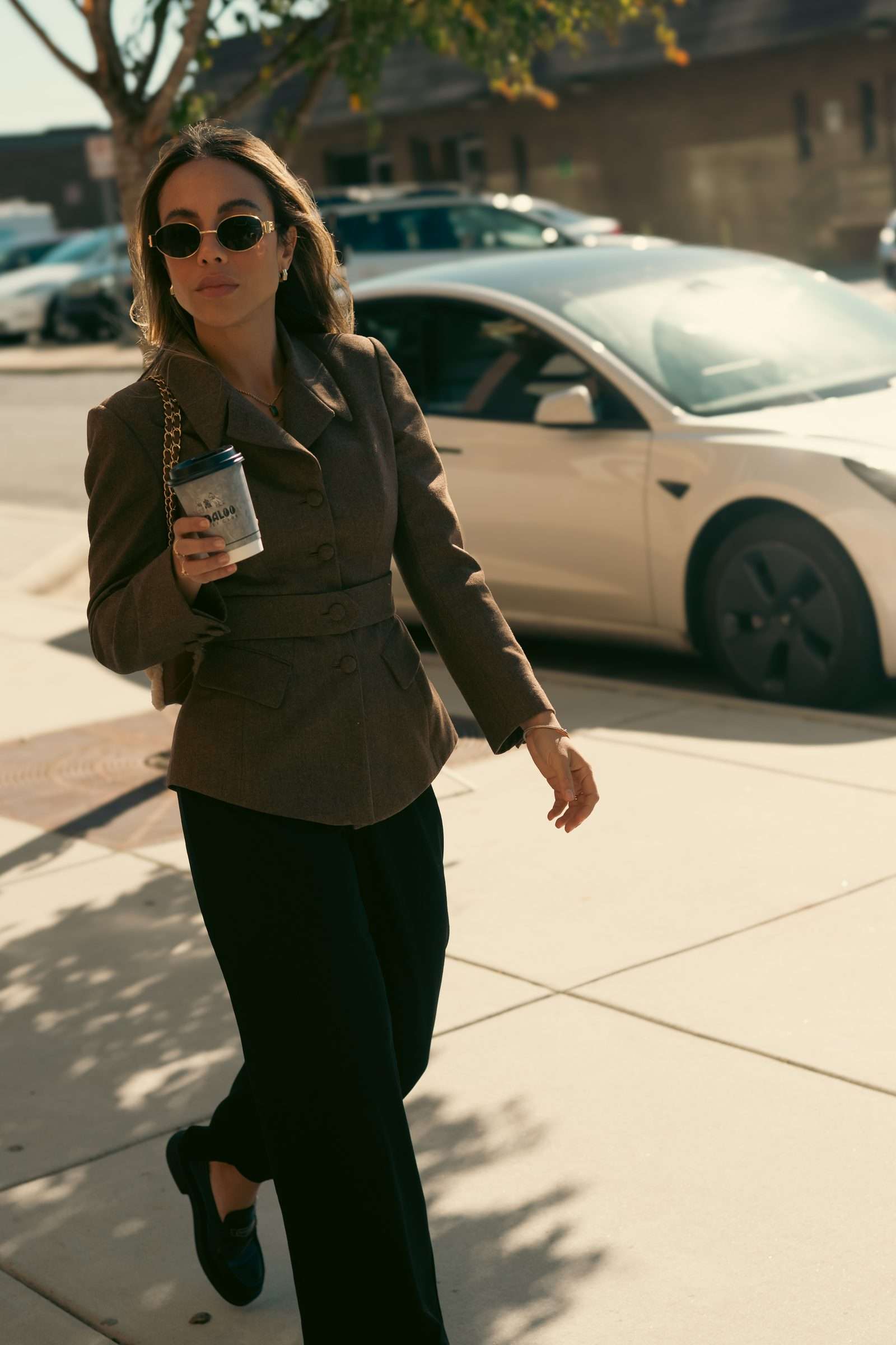 A guest walking down the sidewalk with a Babaloo coffee in hand