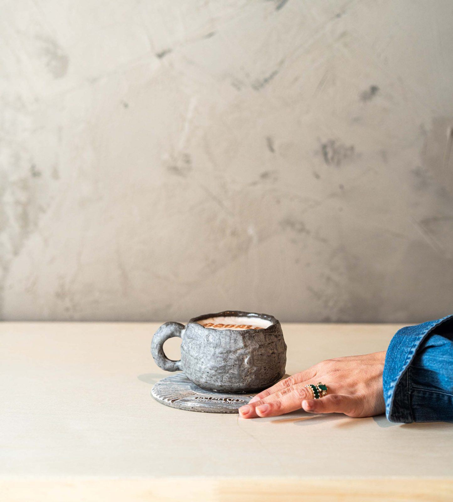 Chai in a stoneware cup held with both hands