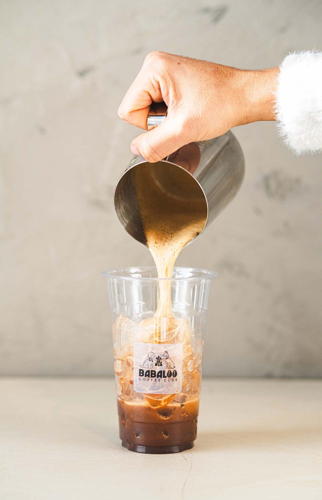 Milk poured over iced espresso